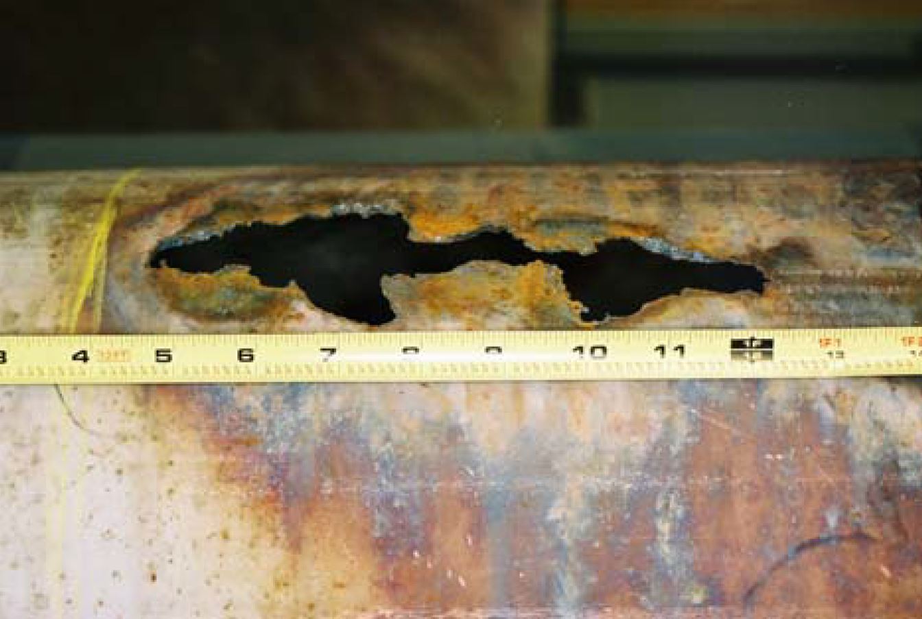 close-up of oxygen fire damage in stainless steel pipe
