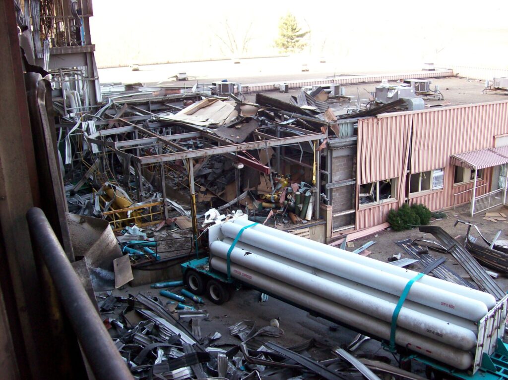 A fatal hydrogen explosion occurred while a tube trailer (right) filled onsite hydrogen storage cylinders (yellow tanks, left).